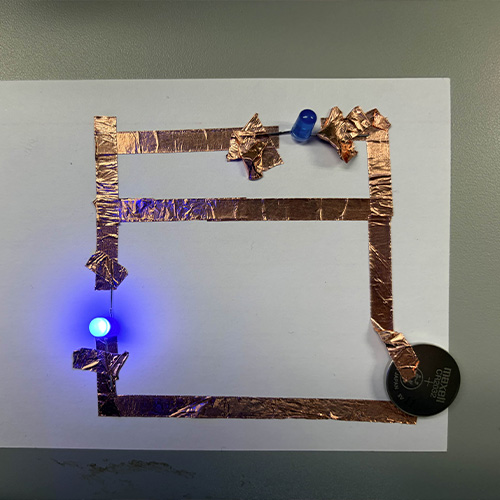 This was my first attempt at a parallel circuit. This was before I explored the diagrams from lectures and before playing around with the class examples. Was not made correctly and first time using copper tape so it was very messy.
